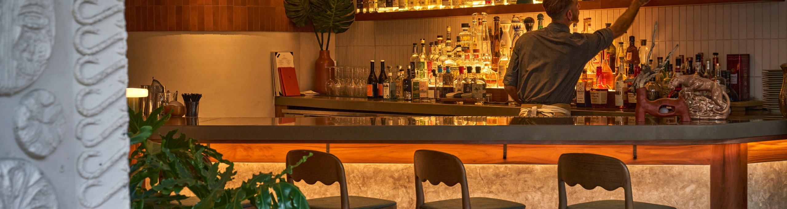 a bartender working behind the bar